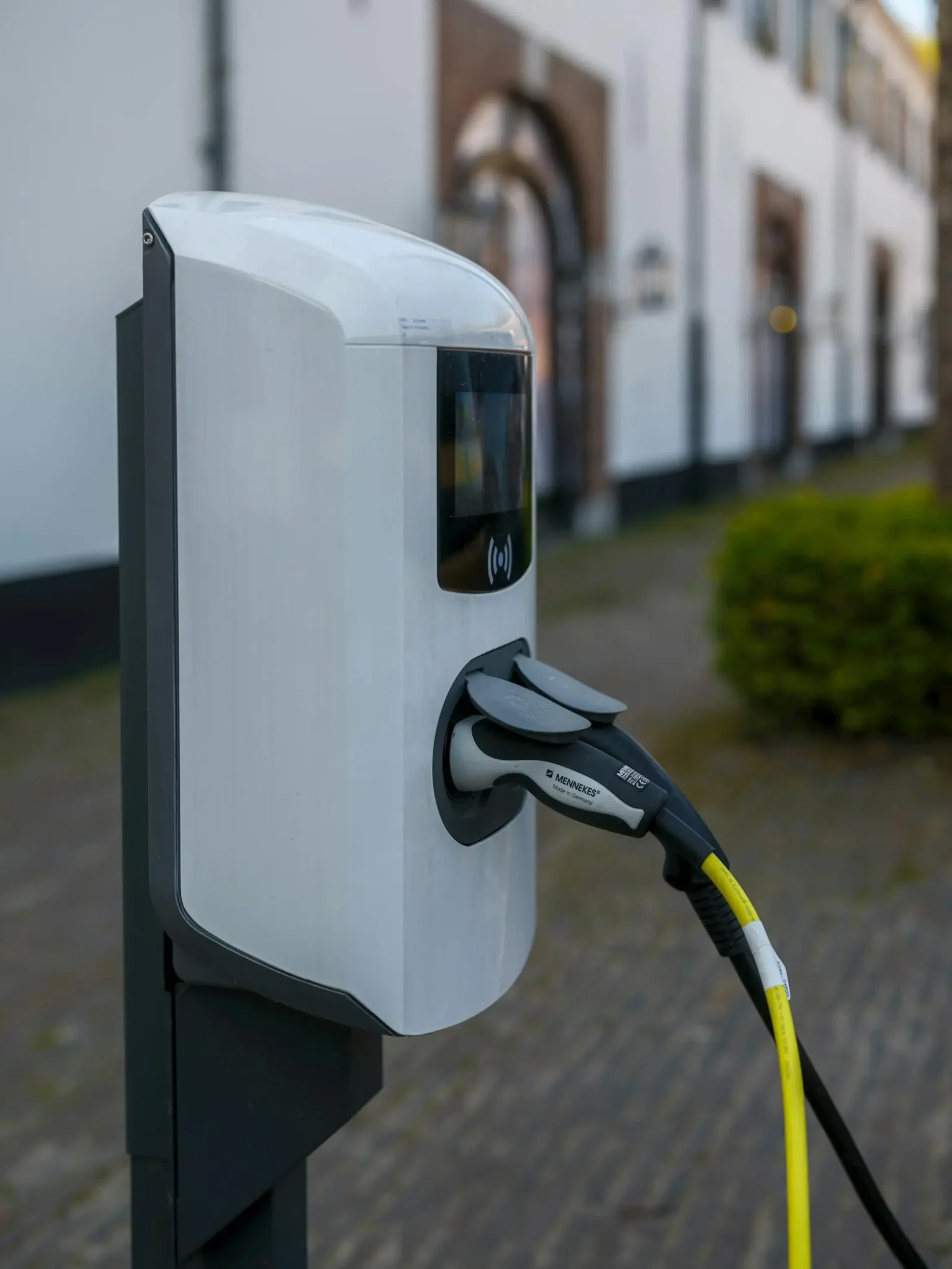 Electric vehicle charging station with cable and plug connected outdoors - plug-in EV charger